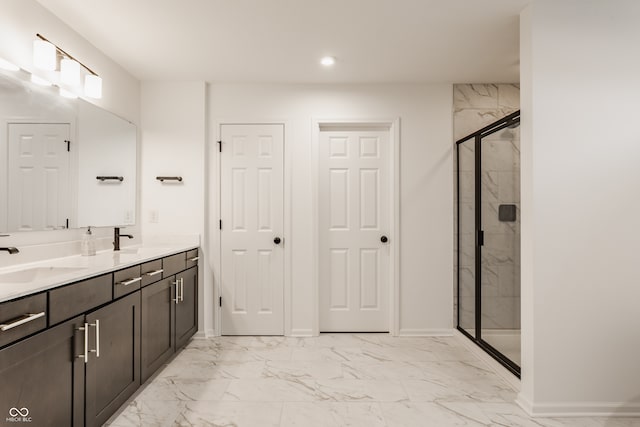 bathroom with vanity and a shower with door