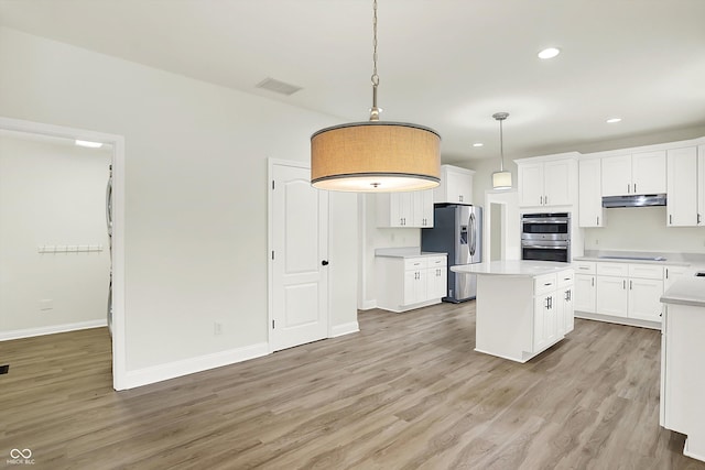 794 Princeton Ln, Westfield, IN 46074 - kitchen with stainless steel appliances, under cabinet range hood, light wood-style floors, white cabinets, and recessed lighting