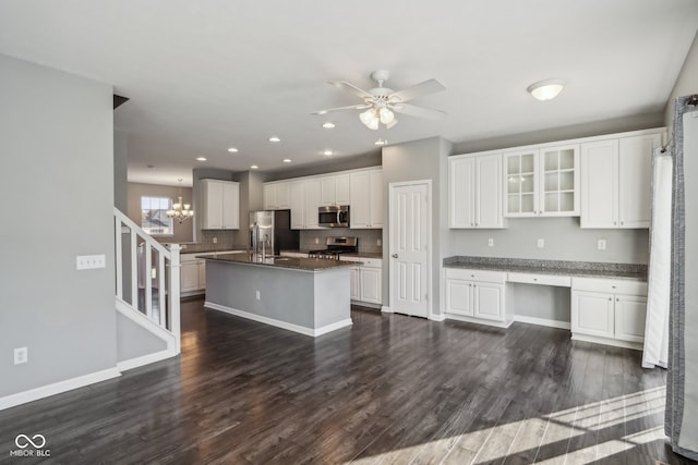 kitchen featuring dark hardwood / wood-style floors, stainless steel appliances, a center island with sink, white cabinetry, and ceiling fan