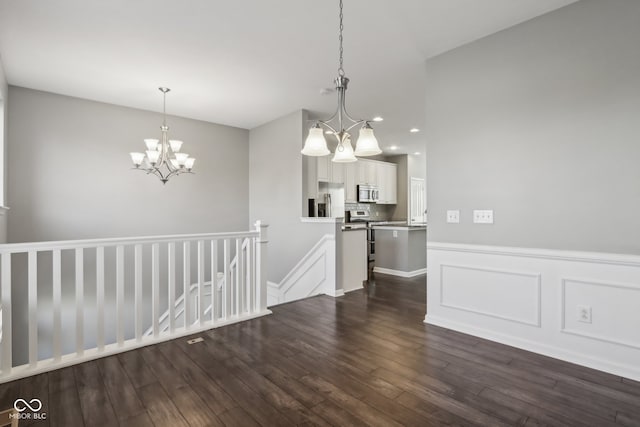 unfurnished dining area with dark wood-type flooring