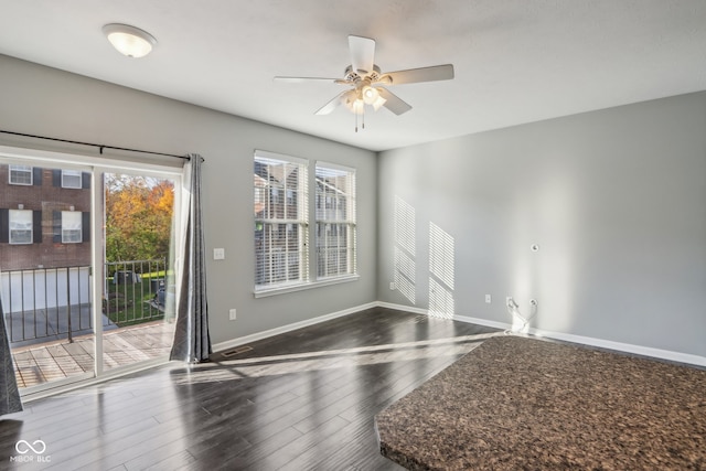 spare room with ceiling fan and dark hardwood / wood-style flooring