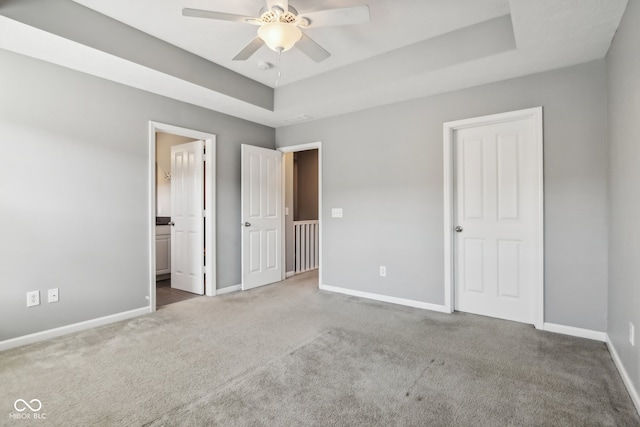 unfurnished bedroom with ceiling fan, carpet, and ensuite bathroom