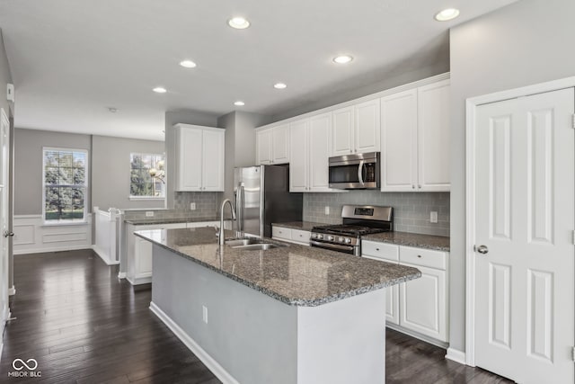 kitchen featuring dark wood-type flooring, appliances with stainless steel finishes, and white cabinetry