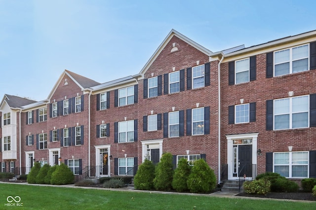 view of property featuring a front lawn