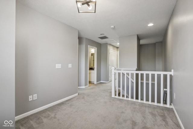 hallway featuring light carpet