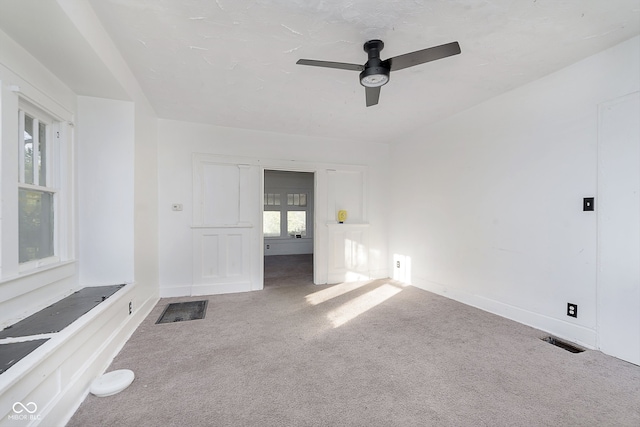 interior space with carpet and ceiling fan