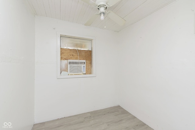 unfurnished room with wood ceiling, light hardwood / wood-style flooring, cooling unit, and ceiling fan