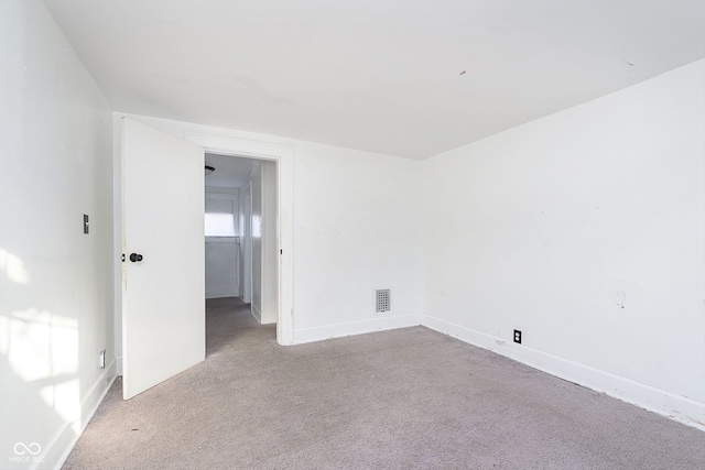 empty room featuring light carpet