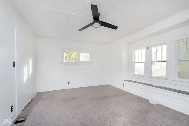 spare room featuring carpet and ceiling fan