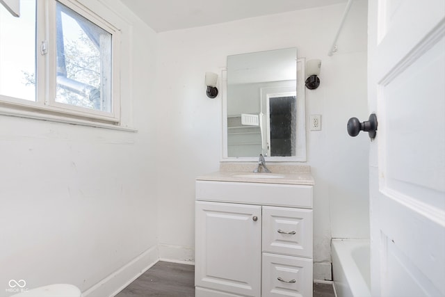 full bathroom featuring vanity, toilet, wood-type flooring, and shower / washtub combination