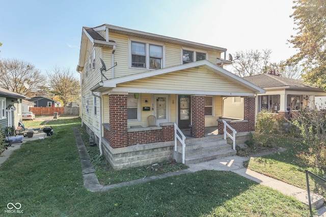 view of front of property featuring a front yard and a porch