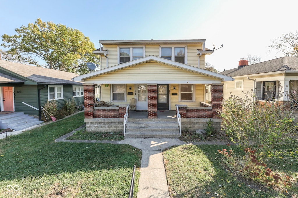 view of front of house featuring a porch and a front yard