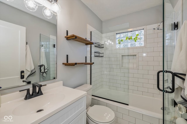 full bathroom with vanity, toilet, and enclosed tub / shower combo