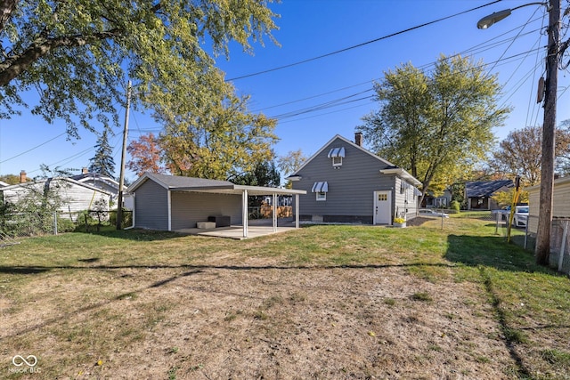 back of property with a yard and a patio