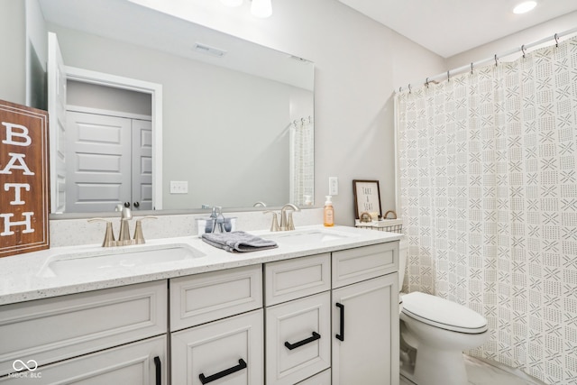 bathroom featuring vanity and toilet