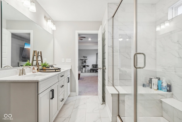 bathroom with vanity and a shower with door