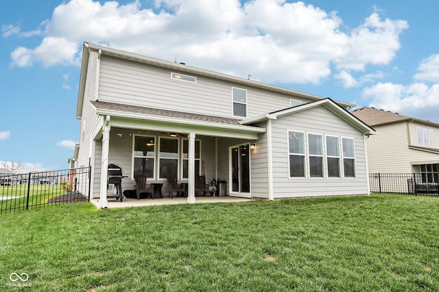 back of house featuring ceiling fan, a yard, and a patio