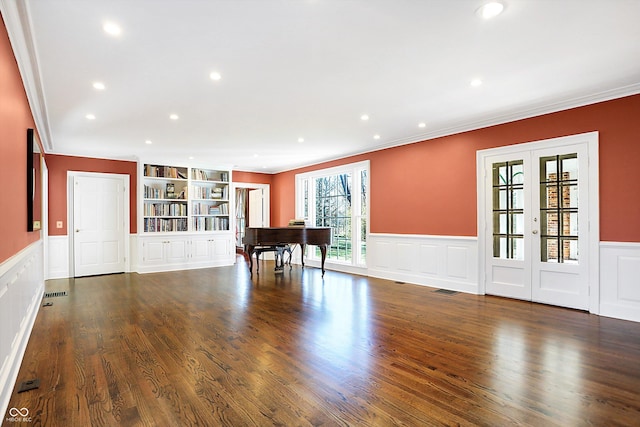 recreation room featuring french doors, crown molding, and dark wood-type flooring