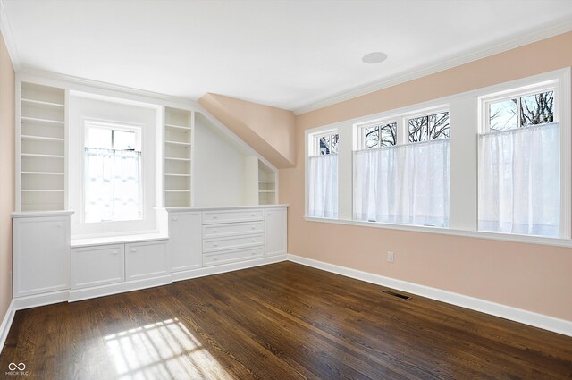 unfurnished room featuring dark hardwood / wood-style floors, crown molding, and a healthy amount of sunlight