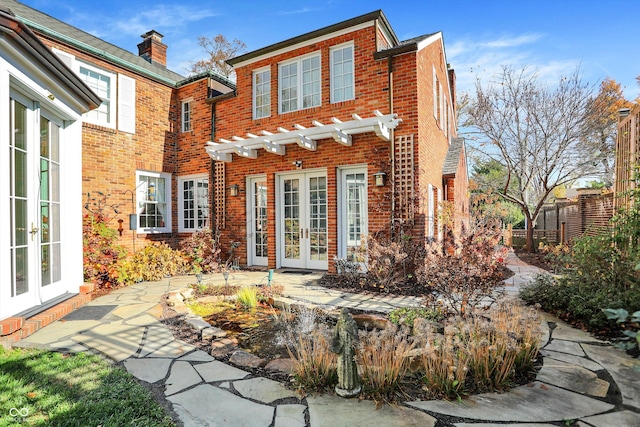 rear view of house featuring french doors