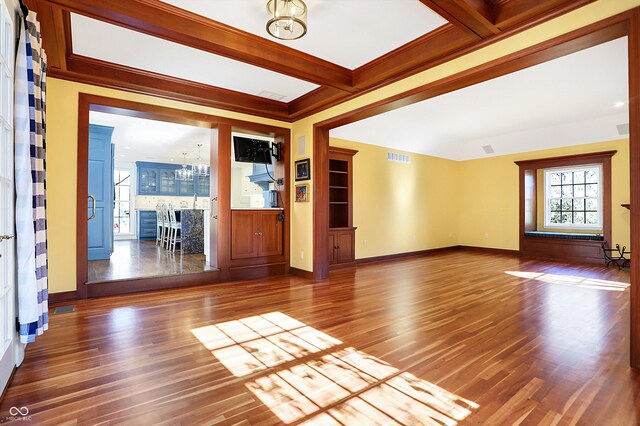 2505 Riverside Dr, Columbus, IN 47201 - unfurnished living room with a chandelier, wood finished floors, baseboards, and beam ceiling