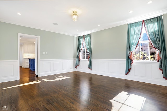 spare room featuring dark hardwood / wood-style flooring and ornamental molding