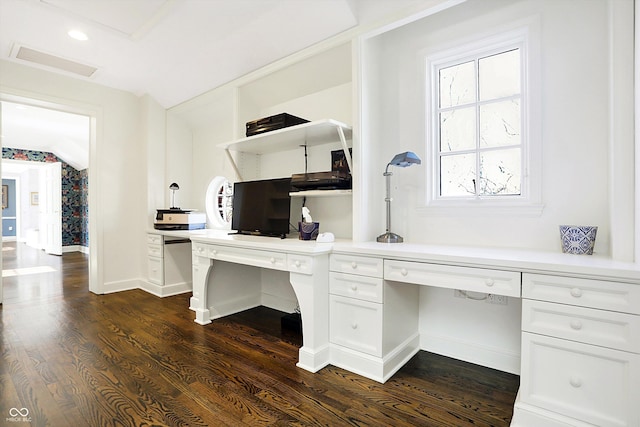 office area featuring dark hardwood / wood-style flooring, built in desk, and lofted ceiling