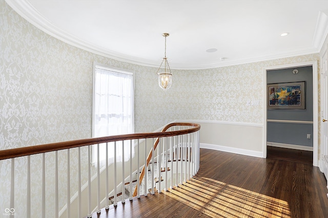 2505 Riverside Dr, Columbus, IN 47201 - corridor featuring wood finished floors, wallpapered walls, ornamental molding, and an upstairs landing