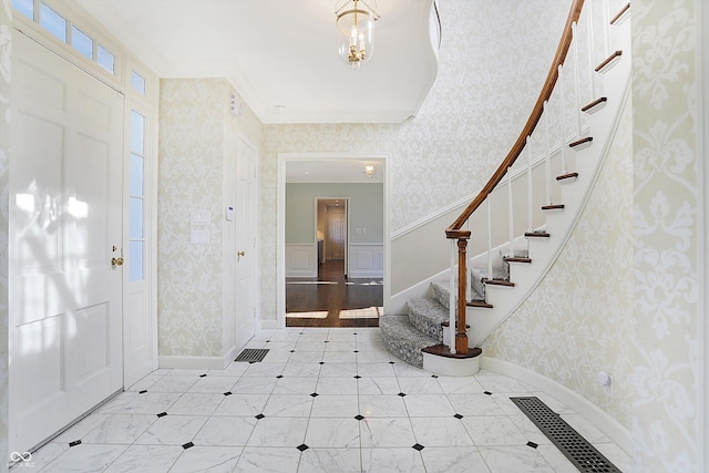 foyer featuring ornamental molding