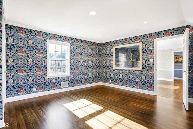 2505 Riverside Dr, Columbus, IN 47201 - spare room with crown molding, wallpapered walls, wood finished floors, and baseboards