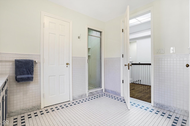 2505 Riverside Dr, Columbus, IN 47201 - bathroom with tile walls, a wainscoted wall, tile patterned floors, and vanity