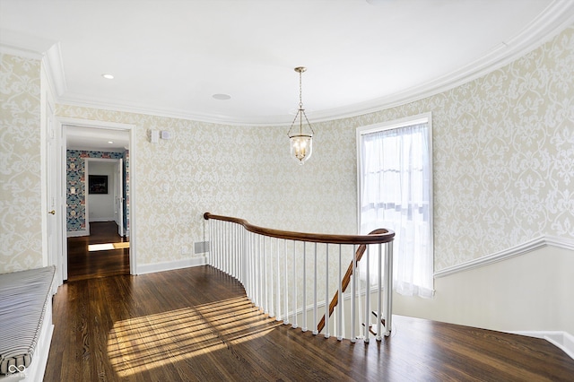 2505 Riverside Dr, Columbus, IN 47201 - hallway featuring an upstairs landing, wood finished floors, wallpapered walls, and ornamental molding