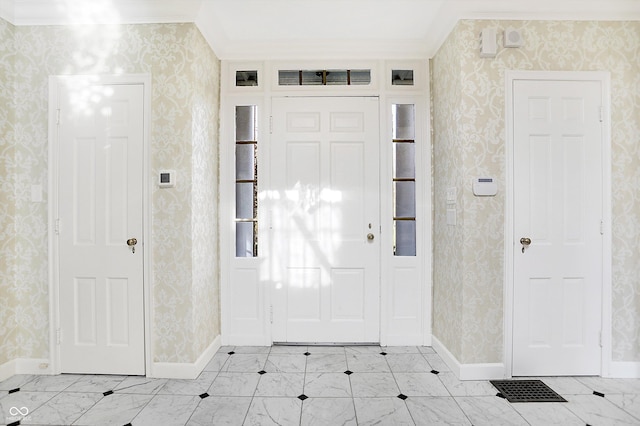 2505 Riverside Dr, Columbus, IN 47201 - foyer entrance featuring wallpapered walls, crown molding, and baseboards