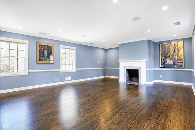 unfurnished living room featuring dark hardwood / wood-style flooring, a healthy amount of sunlight, and ornamental molding