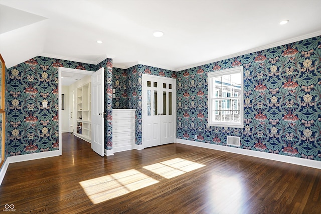 spare room featuring dark hardwood / wood-style floors and ornamental molding