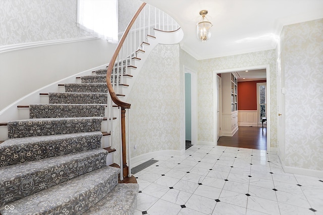 stairway with crown molding and wood-type flooring