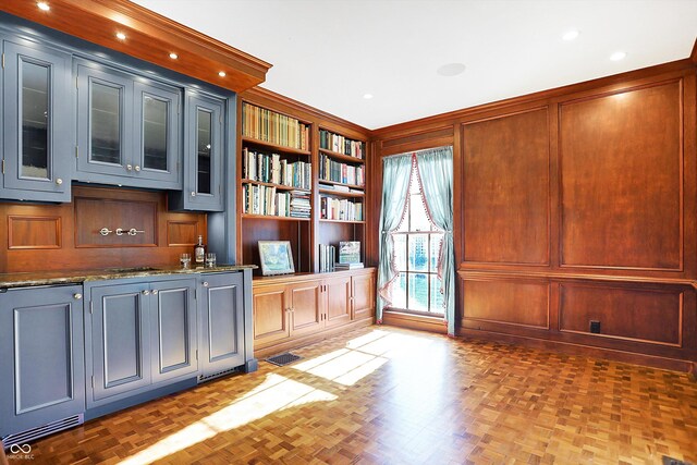 interior space featuring wood walls and dark parquet floors