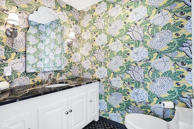 bathroom featuring tile patterned flooring, vanity, and toilet