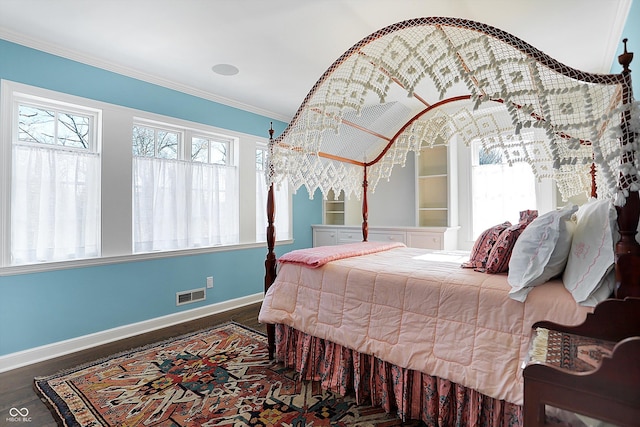 bedroom featuring dark hardwood / wood-style flooring and crown molding