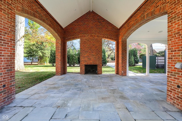 view of patio with an outdoor brick fireplace