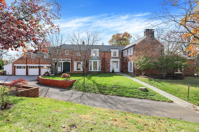 view of front facade with a front lawn and a garage