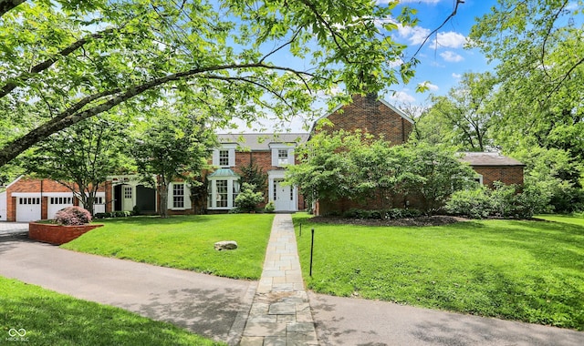 2505 Riverside Dr, Columbus, IN 47201 - view of front of home with brick siding, a front yard, and a garage