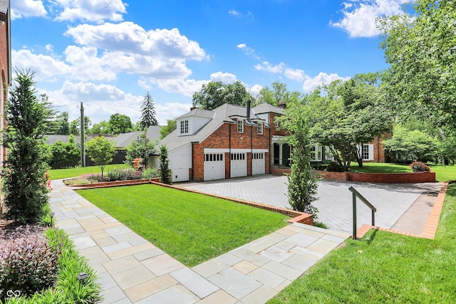 2505 Riverside Dr, Columbus, IN 47201 - view of front of home with brick siding, driveway, a front yard, and a garage