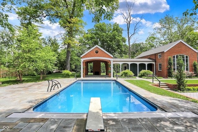 2505 Riverside Dr, Columbus, IN 47201 - swimming pool featuring a lawn, a patio, and a diving board