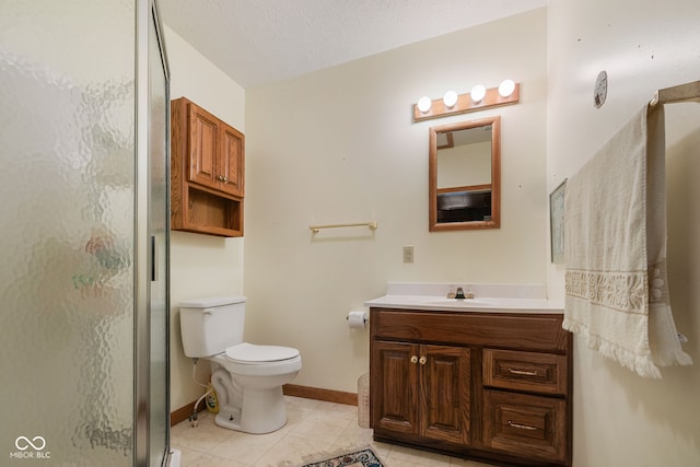 bathroom with a textured ceiling, toilet, a shower with shower door, vanity, and tile patterned flooring