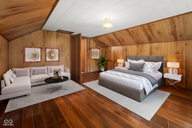 bedroom featuring wood walls, hardwood / wood-style flooring, and vaulted ceiling