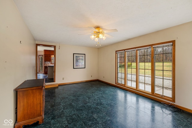 spare room with a textured ceiling and ceiling fan