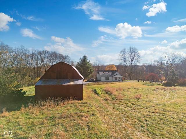 view of yard featuring a rural view and an outbuilding