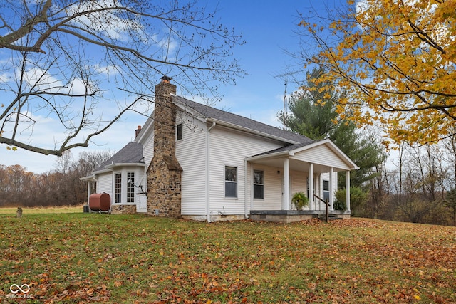 view of home's exterior featuring a yard and covered porch