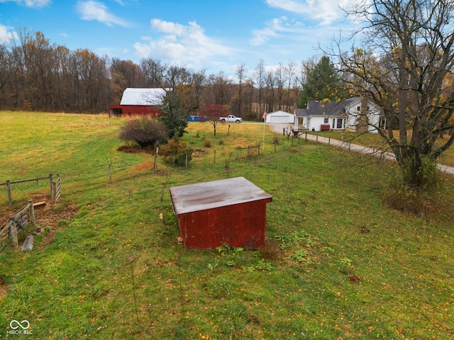 view of yard with a storage shed and a rural view